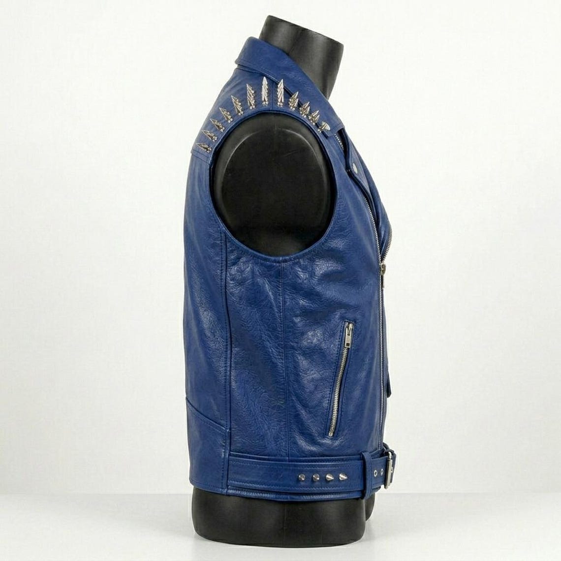 Side view of blue leather biker vest with studded shoulder design