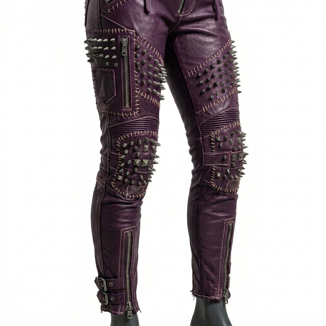 Close up of metal studs and spikes on orange leather pant
