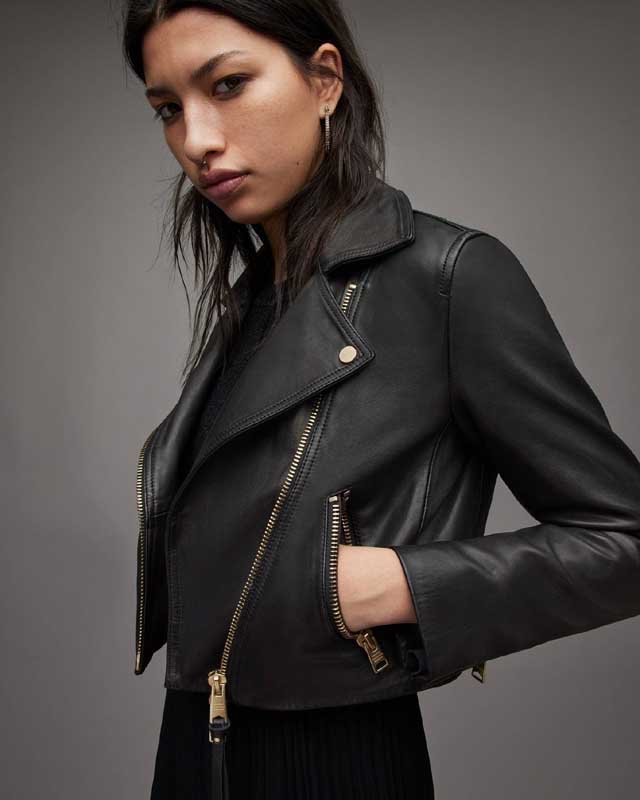 Women's biker jacket featuring gold-tone zipper cuffs
