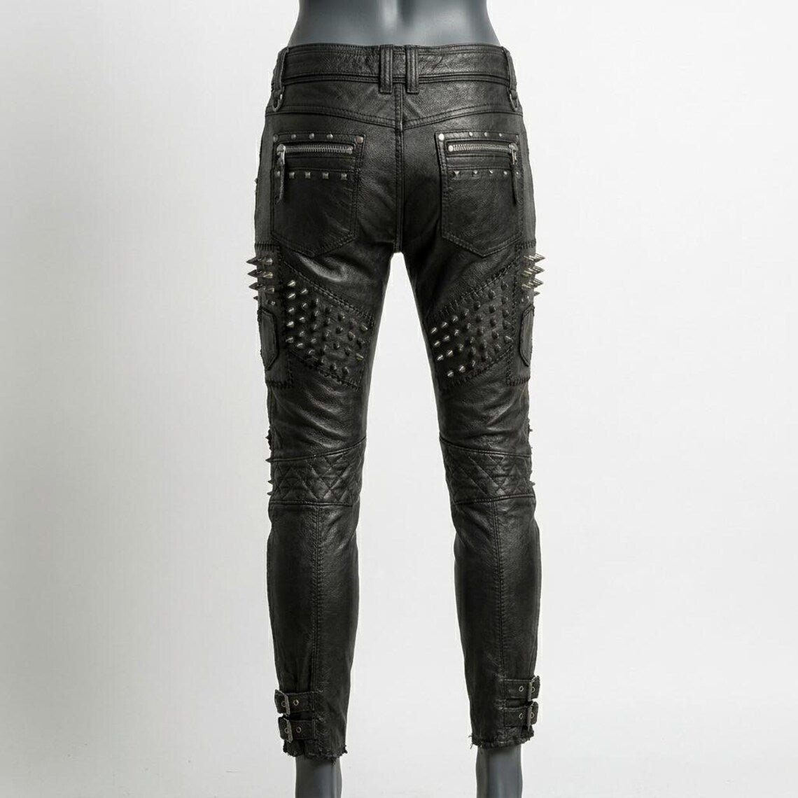  Back view of womens black studded leather pant highlighting sleek silhouette