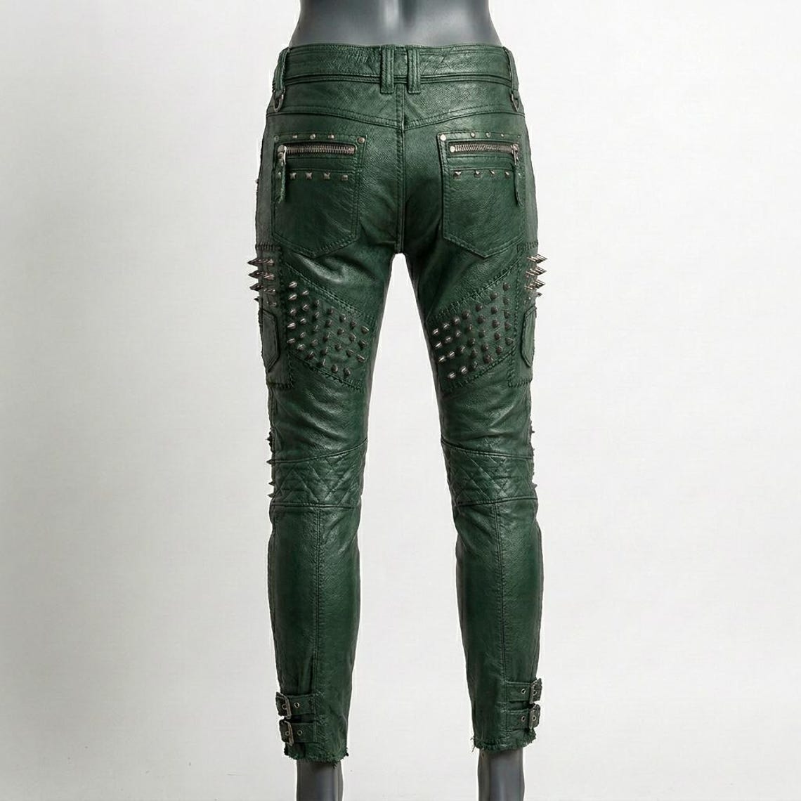  Back fit of women green studded leather pant showing skinny biker silhouette
