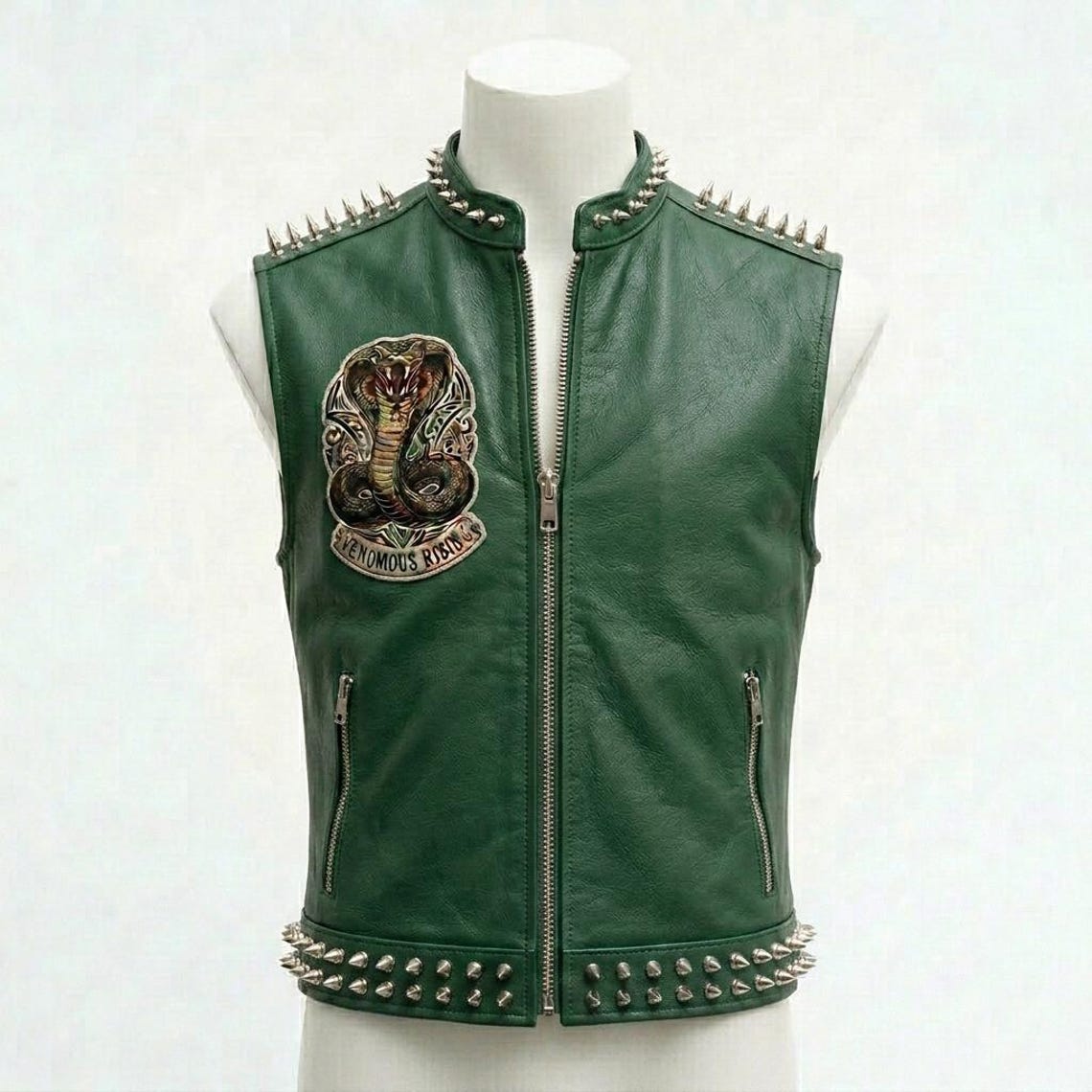Front view of men green leather biker vest with embroidered patch and studded detail