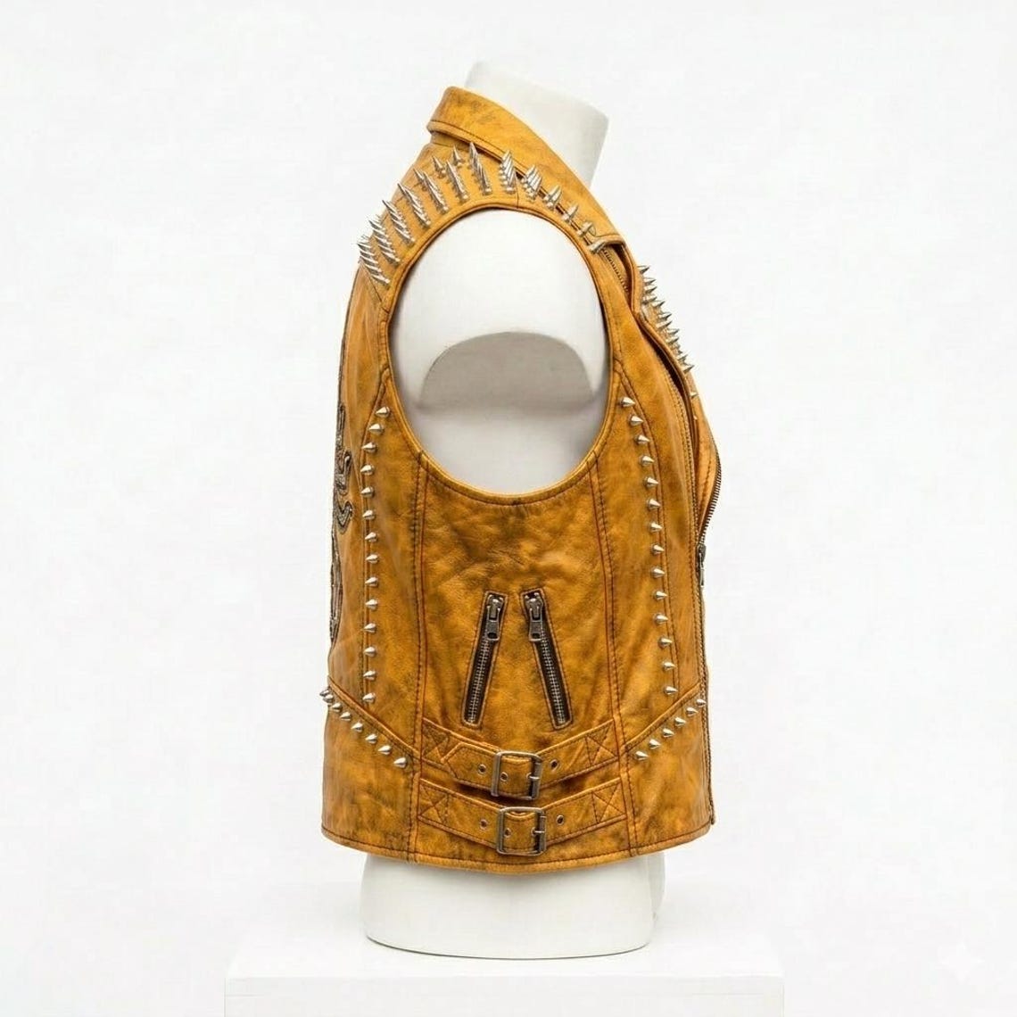 Side view of men yellow leather punk biker vest with spike detail and embroidered design