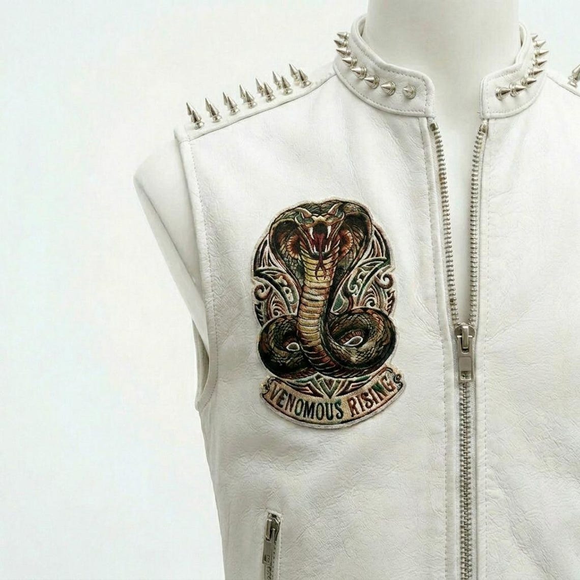 Close up of studded accents on men white leather biker vest